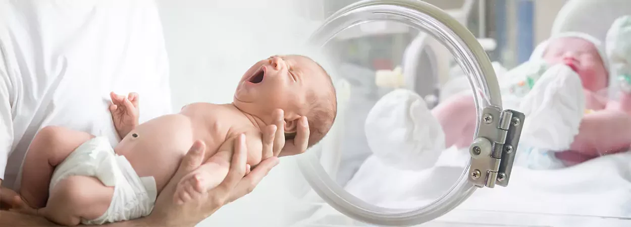 hands holding a new born in a medical facility