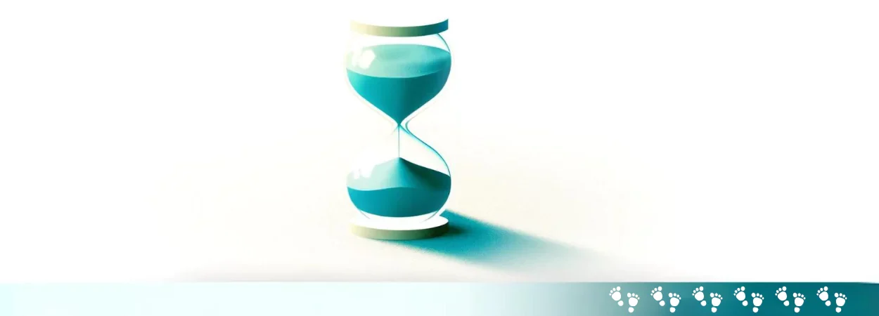 a sand time watch and a frame that has baby steps