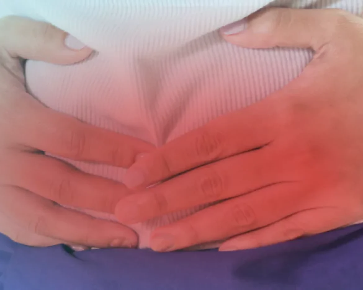 a man holding his abdomen in pain due to irritable bowl syndrome